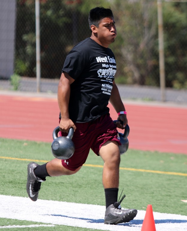 A West Covina lineman participates in the kettle bell run.