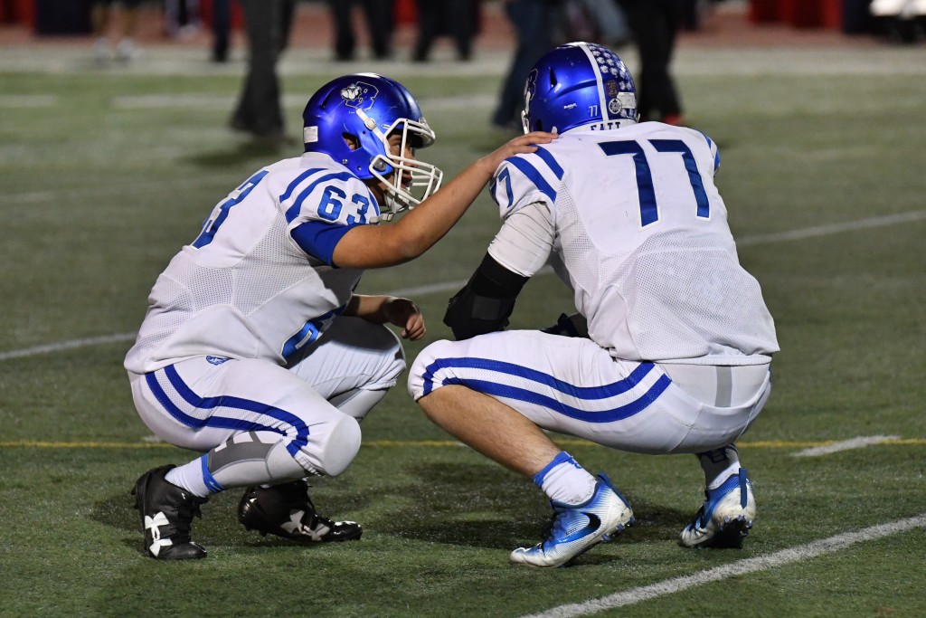 Jonathan Escobar (#63) consoles teammate Scott Breslin (#77) at the end. (Photo by Downtown Doug Brown)