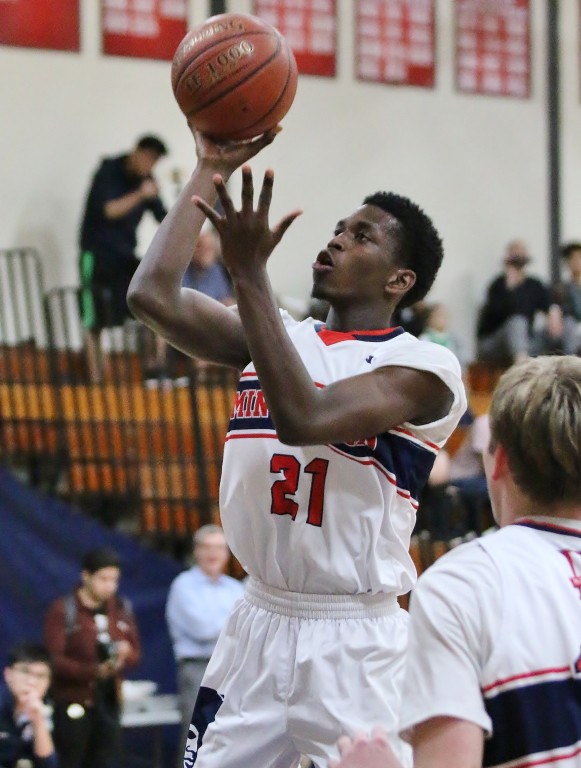 Marcus Reedy glides to the hoop for the Minutemen. (Photo by Duane Barker) 